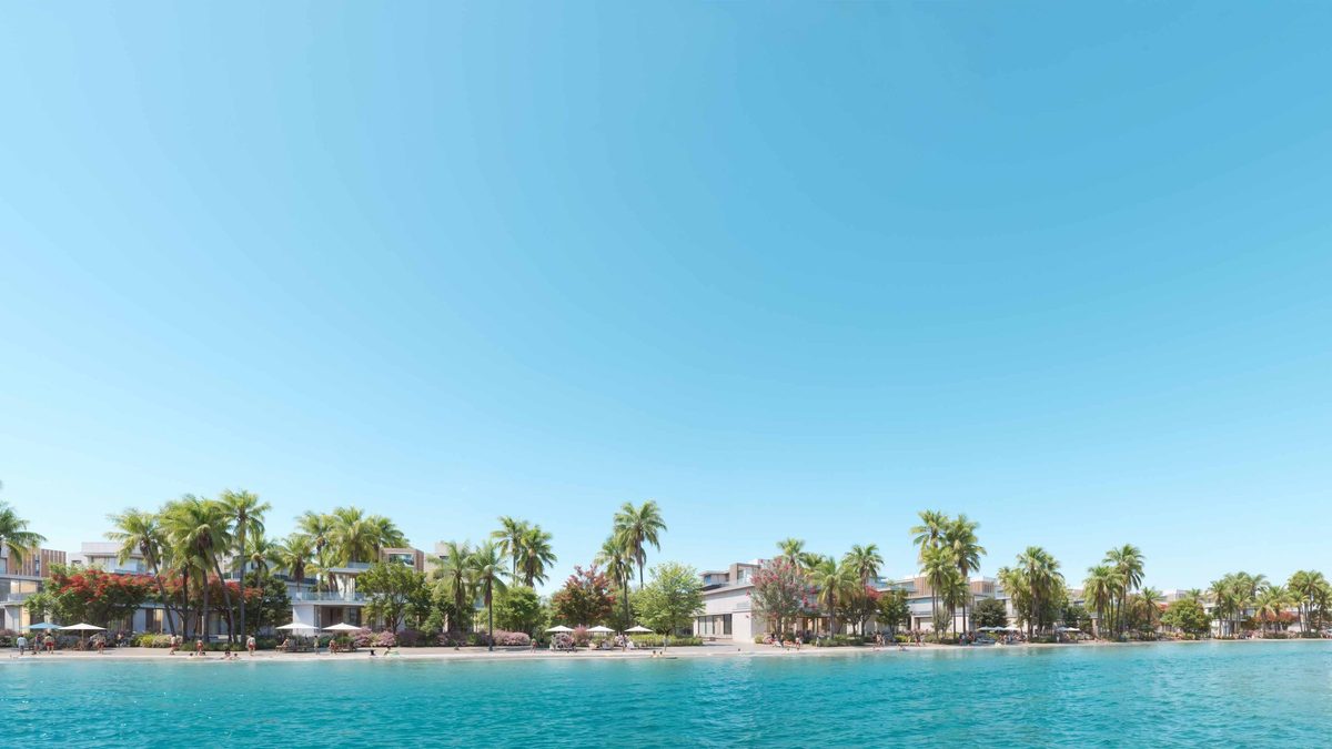 The lagoon at DAMAC Islands: white beach, still water, a palm belt and the clubhouse on the far shore, from the developer's brochure