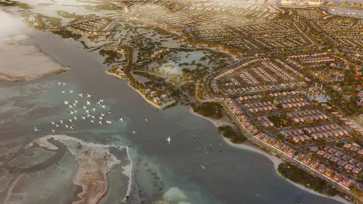 Saadiyat Lagoons from the air: mangrove channels, flamingos, villa clusters running to the shoreline