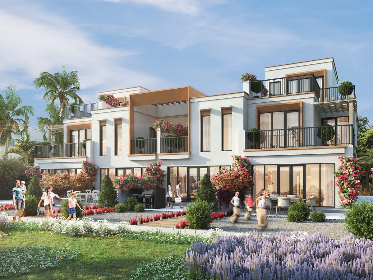 A villa at DAMAC Lagoons from the lawn: white and stone Mediterranean façade