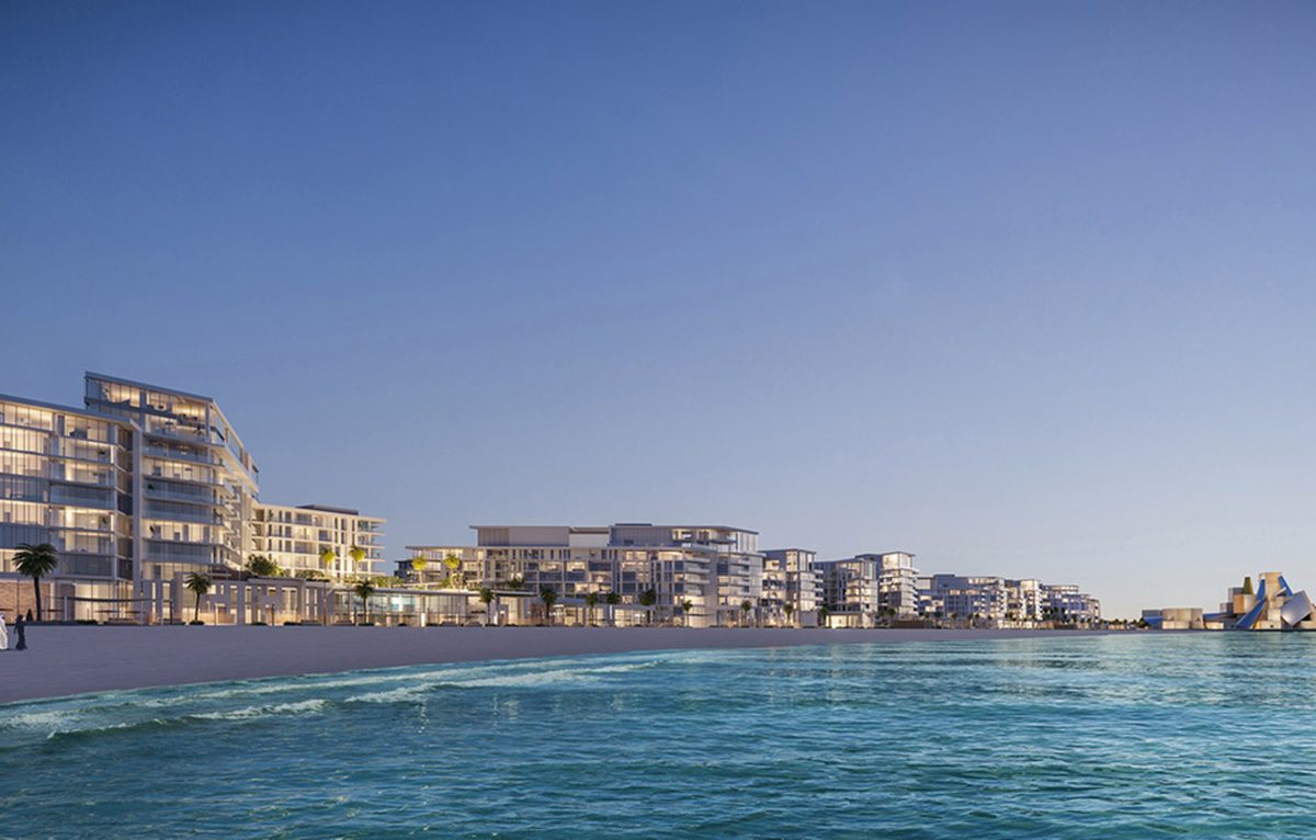 The Mamsha Al Saadiyat beachfront row seen from the water, the Louvre Abu Dhabi dome at the far end